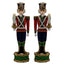 Two decorative nutcracker figurines holding candles on a white background